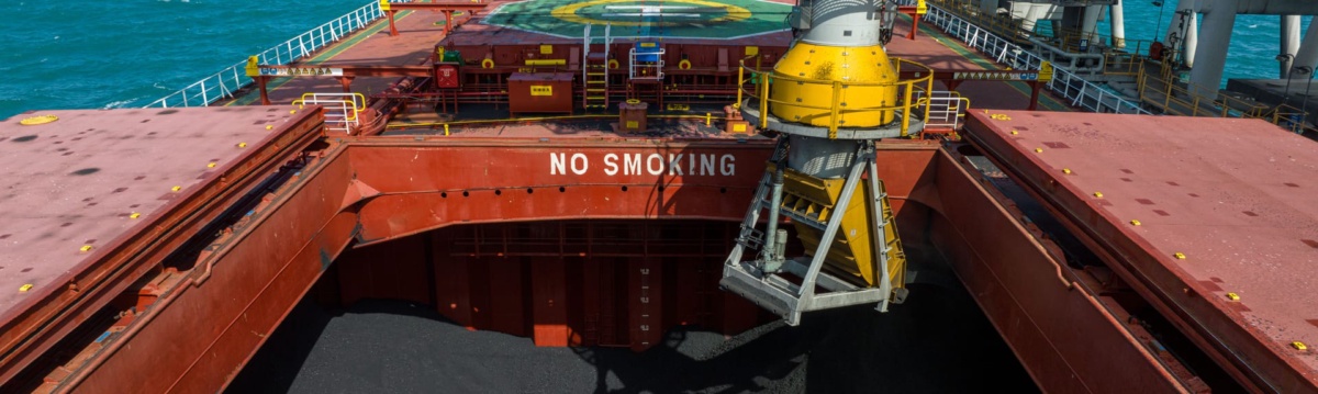 Coal being loaded into the hold of a bulk carrier