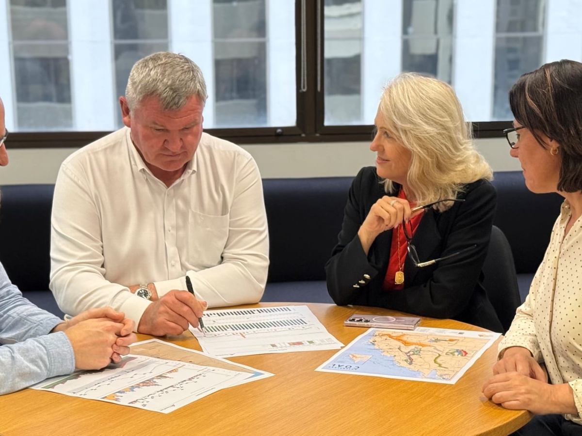 Faith Dempsey and Bob Skuza reviewing shipment data