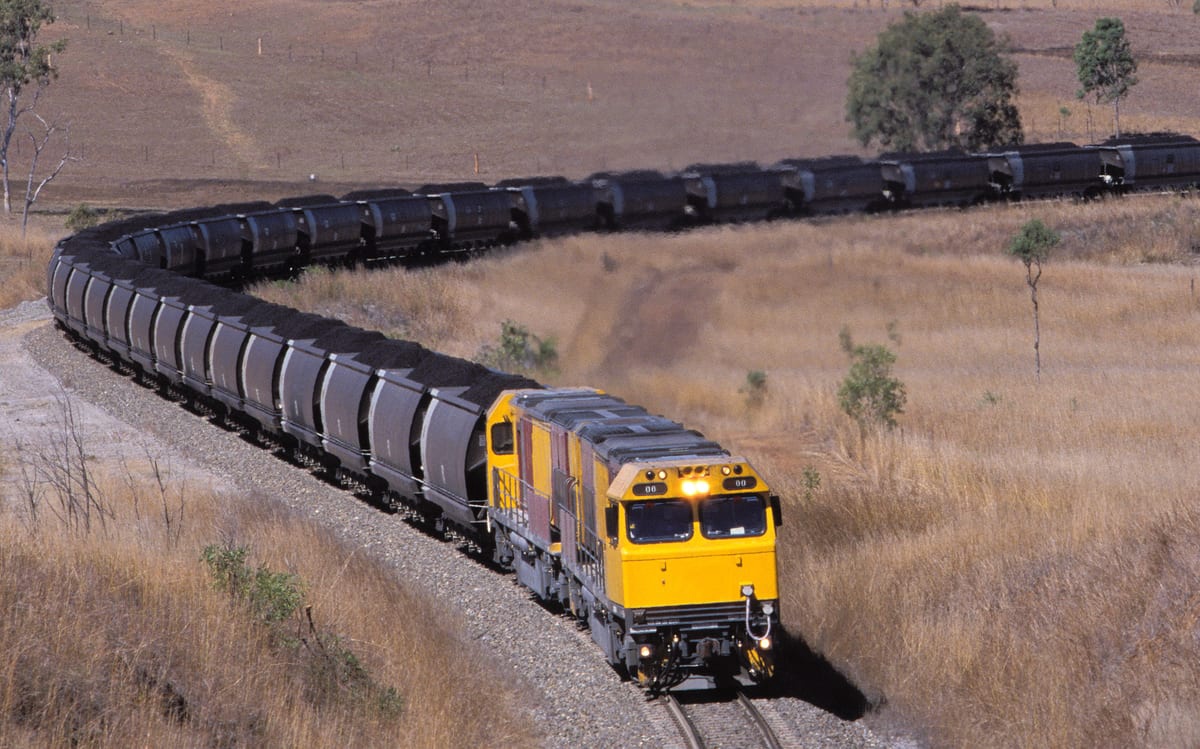 Loaded coal train winding through the Queensland countryside